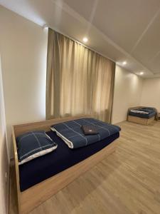 Un pat sau paturi într-o cameră la Baltcity