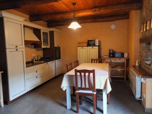 a kitchen with a table and chairs in a room at Apartamento Láncara in Lugo