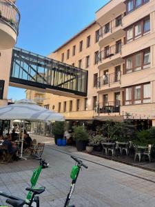 two scooters are parked in front of a building at BDA Budapest Downtown Apartment in Budapest