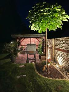 a picnic table in a backyard at night with a tree at Ferienwohnung Summer in Karlshagen