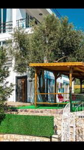 a wooden gazebo with a table and chairs at Just Dream Suites in Kaş