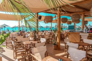 a restaurant on the beach with tables and chairs at Yacht Hotel in Vlorë