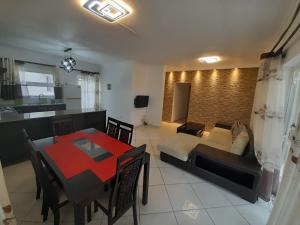 a living room with a couch and a dining room at Le Nid Flic en Flac in Flic-en-Flac