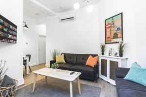 a living room with a couch and a table at Two Bedroom Apartment in Central London with Large Terrace in London