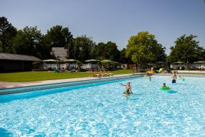 a group of people swimming in a swimming pool at Hof van Salland Hellendoorn in Hellendoorn
