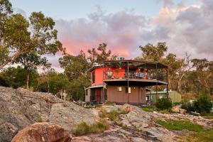 a building on top of a hill with trees at A Stanthorpe Getaway in Ballandean