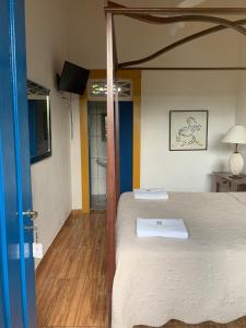Postel nebo postele na pokoji v ubytování Suítes Casa da Colônia