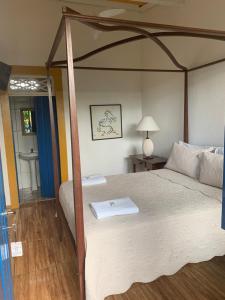 Postel nebo postele na pokoji v ubytování Suítes Casa da Colônia