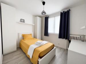 a small bedroom with a bed and a window at Une pause à Evreux logement entier in Évreux