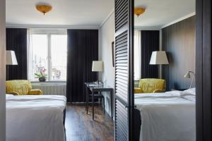 Postel nebo postele na pokoji v ubytování First Hotel Grand
