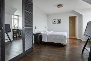 Postel nebo postele na pokoji v ubytování First Hotel Grand