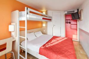 a bedroom with a bed and a bunk bed at Premiere Classe Beauvais in Beauvais