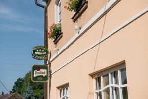 a sign for a restaurant on the side of a building at Pension Herman in Rudník