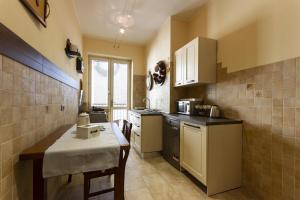 a kitchen with a counter and a table in it at Grace apartment - Smart Holiday in Mantova