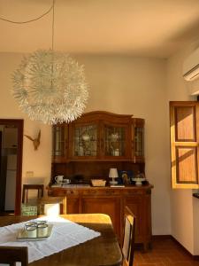 a dining room with a table and a chandelier at La luna e i falò in Arezzo +25 photos