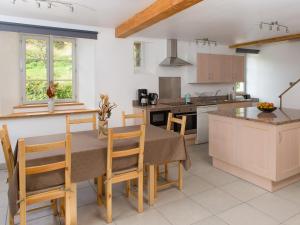 a kitchen with a table and chairs in a room at Loge du Chateau de Pouech in Moulis