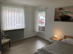a bedroom with a bed and a window at Family Apartment Bavaria in Füssen