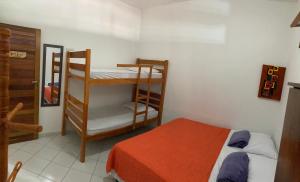 a small room with a bed and a bunk bed and a room with a bed at Villa Nevada Hostel in Bananeiras