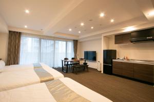 a hotel room with a large bed and a kitchen at Minn Asakusa in Tokyo