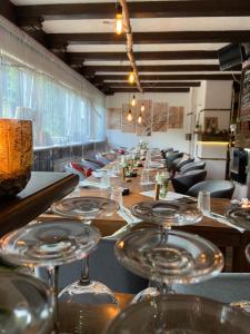 a long table in a restaurant with wine glasses at Vesperstube Michelbach in Gaggenau