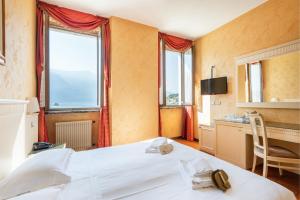 Postel nebo postele na pokoji v ubytování Hotel Le Palme