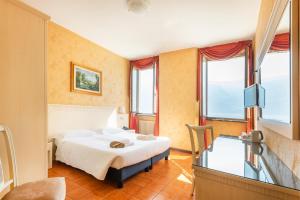 Postel nebo postele na pokoji v ubytování Hotel Le Palme
