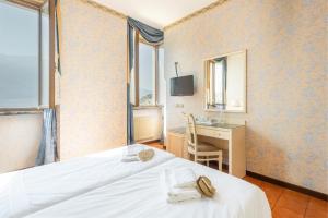 Postel nebo postele na pokoji v ubytování Hotel Le Palme