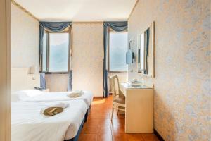 Postel nebo postele na pokoji v ubytování Hotel Le Palme