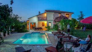 a house with a swimming pool in the backyard at House /Villa Maja in Ližnjan