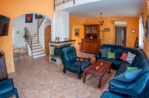 a living room with a couch and chairs and a fireplace at House /Villa Maja in Ližnjan