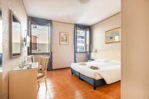 Postel nebo postele na pokoji v ubytování Hotel Le Palme