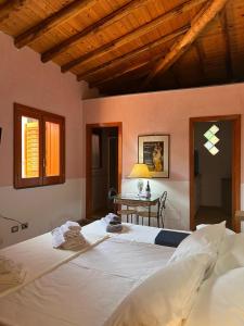 a bedroom with a large bed and a table at Il carrubo in Trecastagni