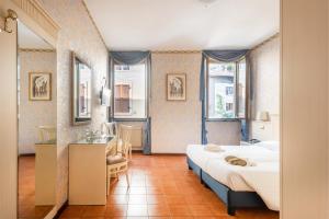Postel nebo postele na pokoji v ubytování Hotel Le Palme