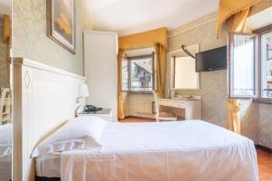 Postel nebo postele na pokoji v ubytování Hotel Le Palme