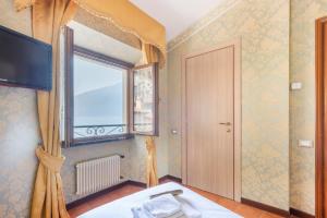 Postel nebo postele na pokoji v ubytování Hotel Le Palme