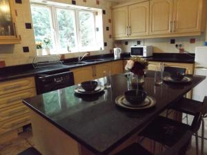 a kitchen with a island with two cups on it at Gainford House in Walsgrave on Sowe