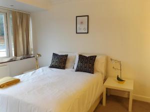um quarto com uma grande cama branca e uma janela em Gainford House em Walsgrave on Sowe