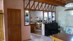 a room with a kitchen and a dining room at Ferme fortifiée du 18e rénovée avec vue in Lacroisille