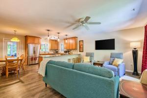 a living room with a blue couch and a kitchen at Nature's Edge in Asheville
