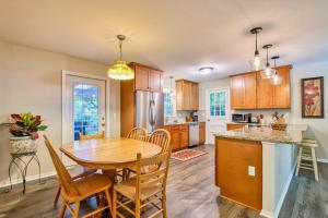 a kitchen and dining room with a wooden table and chairs at Nature's Edge in Asheville