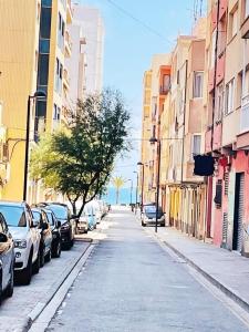 a street with cars parked on the side of the road at Cala Nova Studios, Vinaròs in Vinarós