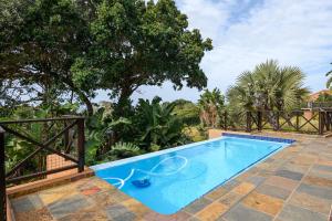 a blue swimming pool with a tennis racket in it at San Lameer Villa - 14308 - 4 Bedroom Deluxe - 8 pax - San Lameer Rental Agency in Southbroom