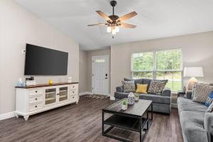 a living room with a couch and a flat screen tv at Pet-friendly, Heated Pool, Close to Everything 3 Bedroom Home in Dunnellon