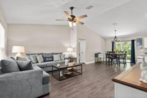 a living room with a couch and a ceiling fan at Pet-friendly, Heated Pool, Close to Everything 3 Bedroom Home in Dunnellon