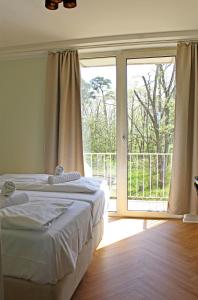 a bedroom with a bed and a sliding glass door at Autobahn Hotel Pfungstadt Ost in Pfungstadt