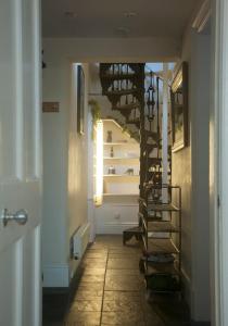 a hallway with a spiral staircase in a house at GuestReady - Charming flat in West End in Edinburgh