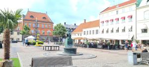 a town with a fountain in the middle of a street at LUXURY CITY VIEW APARTMENT in Kristianstad