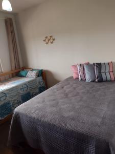 Un pat sau paturi într-o cameră la Apartamento Cobertura