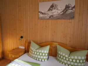 a bedroom with a bed with two pillows at Ferienhaus Pfeifer in Sankt Gallenkirch