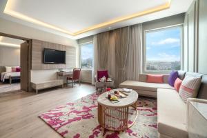 a living room with a couch and a table at Vivanta Ahmedabad SG Highway in Ahmedabad